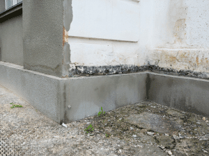 Exterior moisture damage and foundation deterioration observed during a home inspection in Bedford TX