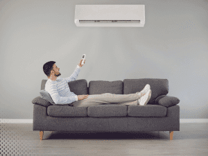 Homeowner adjusting HVAC system while relaxing indoors in Arlington, TX