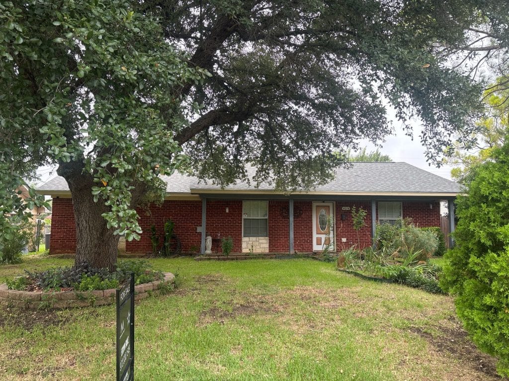 Front exterior of a brick home on Rochelle Road in Irving, TX during a residential home inspection.