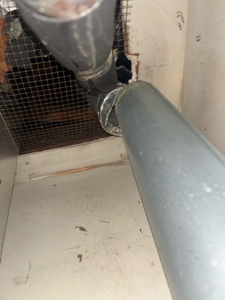 Water heater flue pipe disconnected in the utility closet of a residential home in Irving, TX, inspected by a home inspector to ensure proper exhaust and carbon monoxide safety